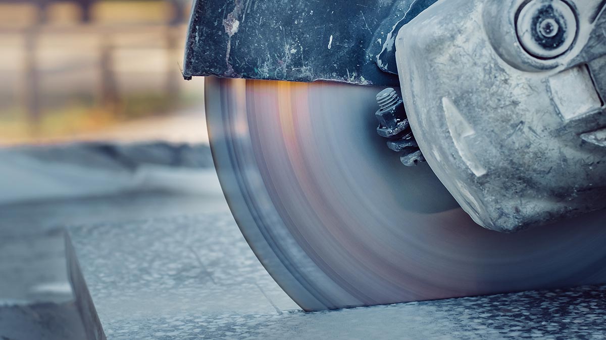 A concrete saw cutting a concrete tile